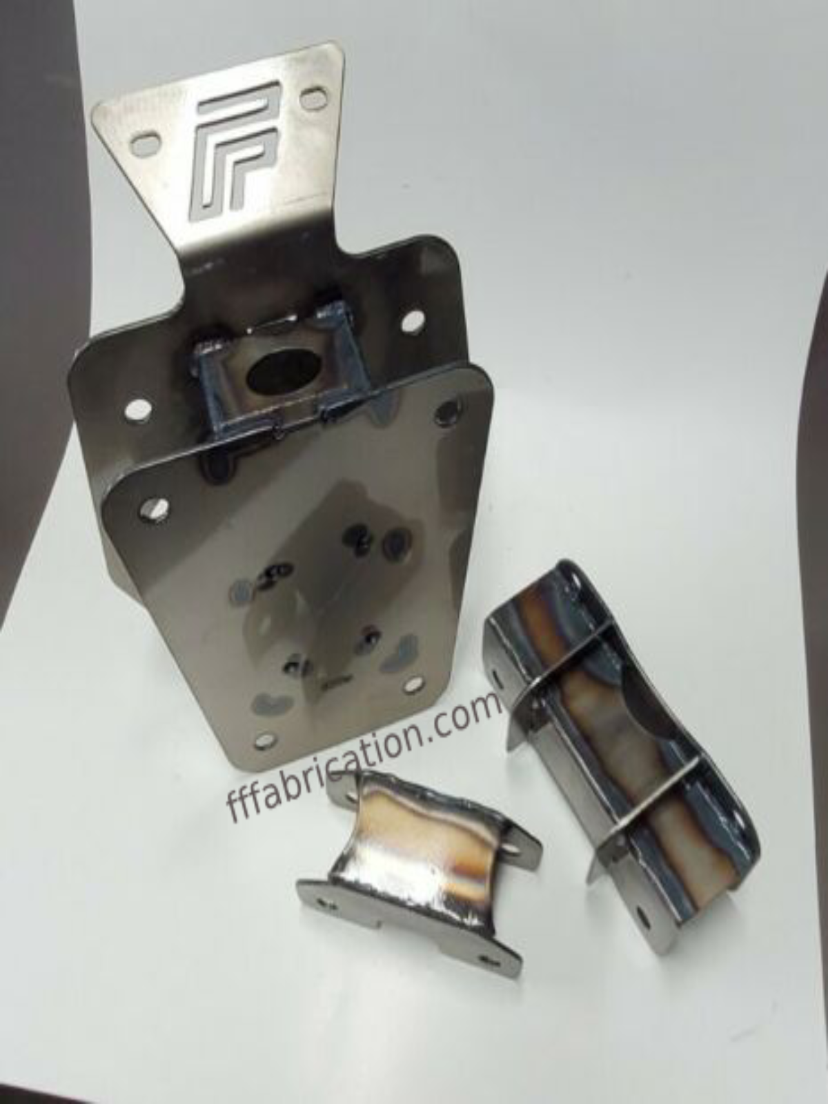 Metal fabrication components on a white background with 'fffabrication.com' branding.