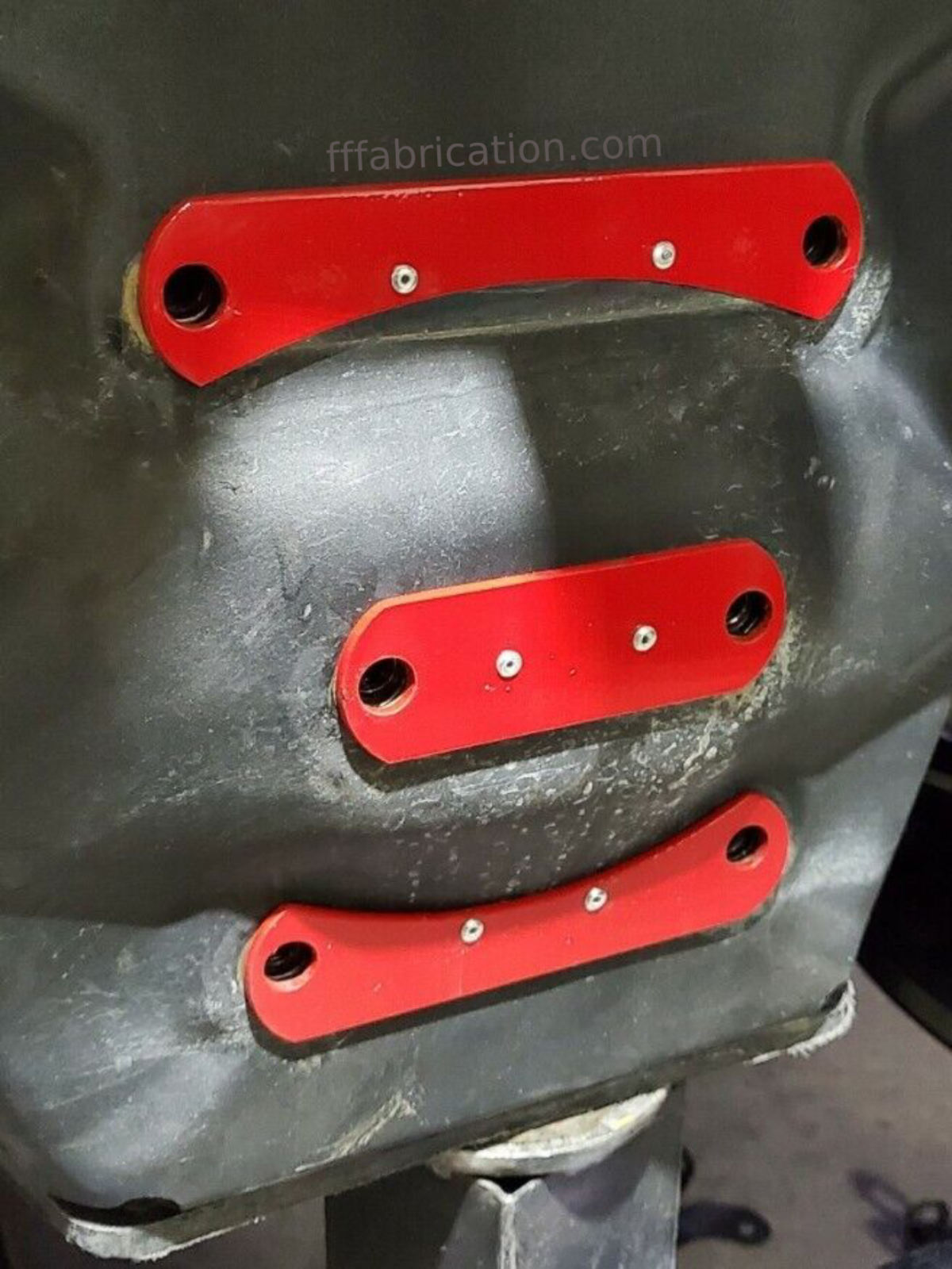 Three red metal brackets on a black surface with 'fffabrication.com' text.