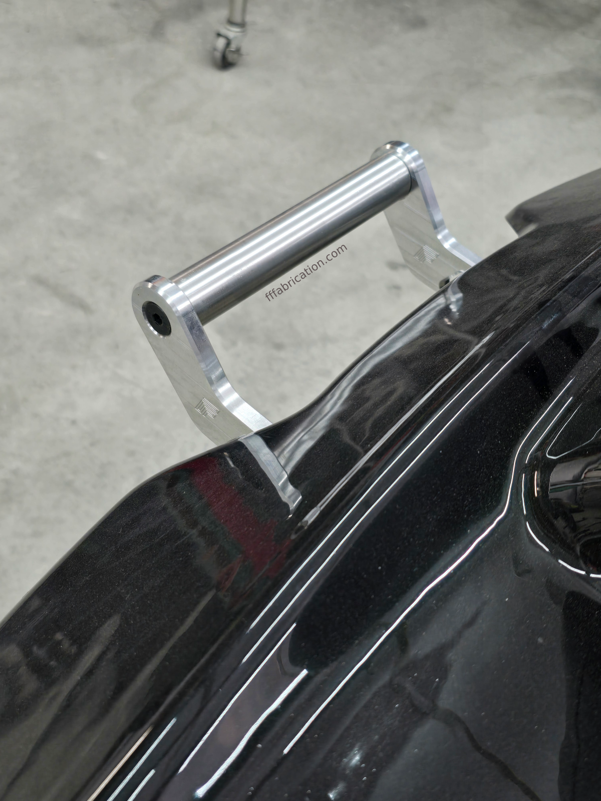 Metal luggage rack on a black vehicle with a blurred background