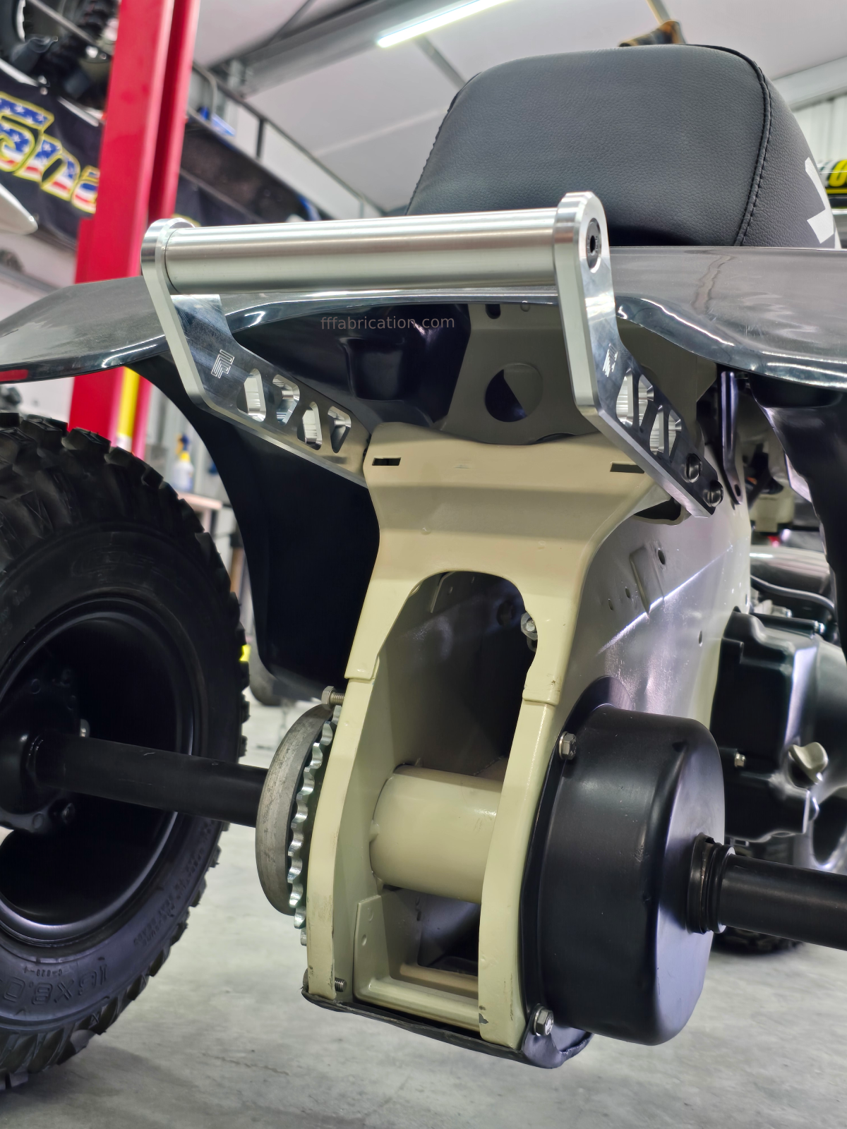 Close-up of a scooter with a visible brand logo in a garage setting