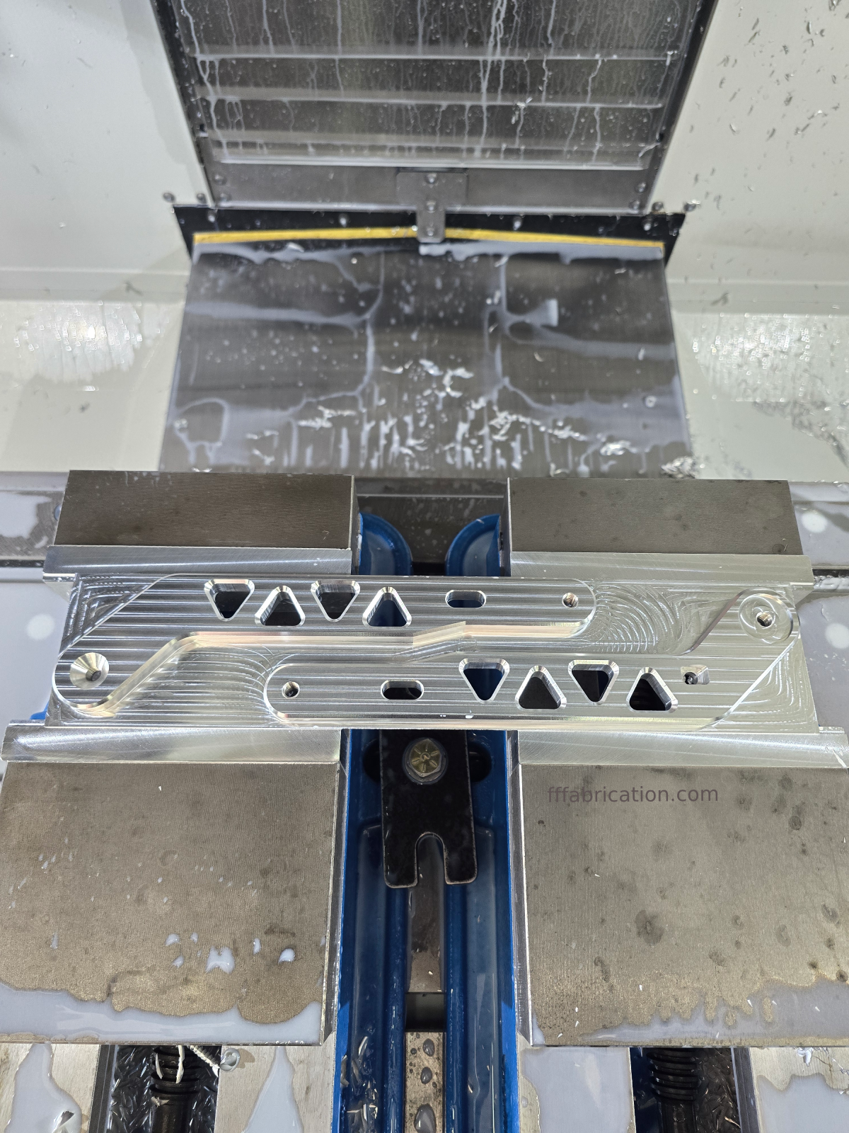 Metallic component with a textured surface on a white background