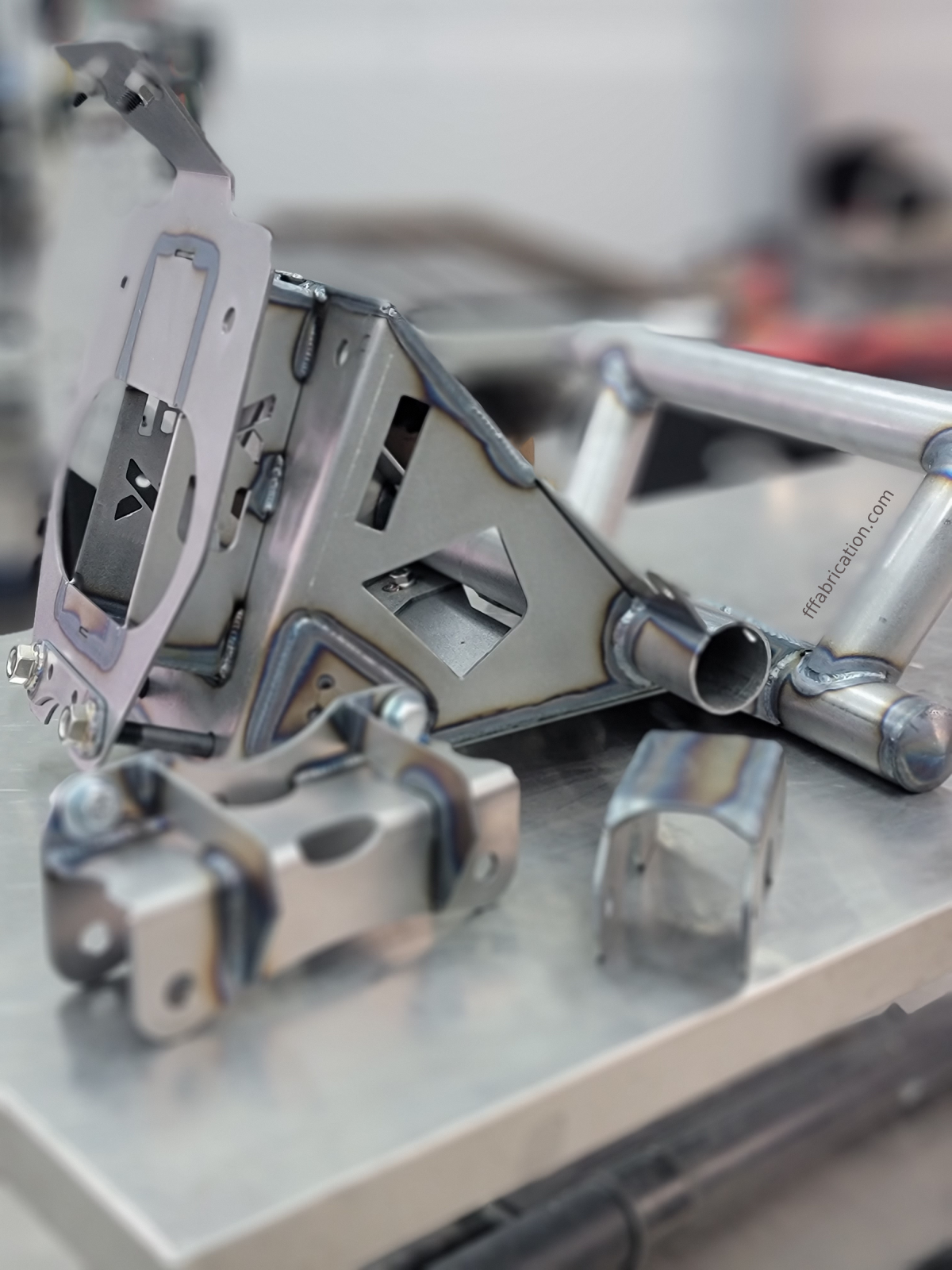 Metallic tripod head and leg on a reflective surface with blurred background