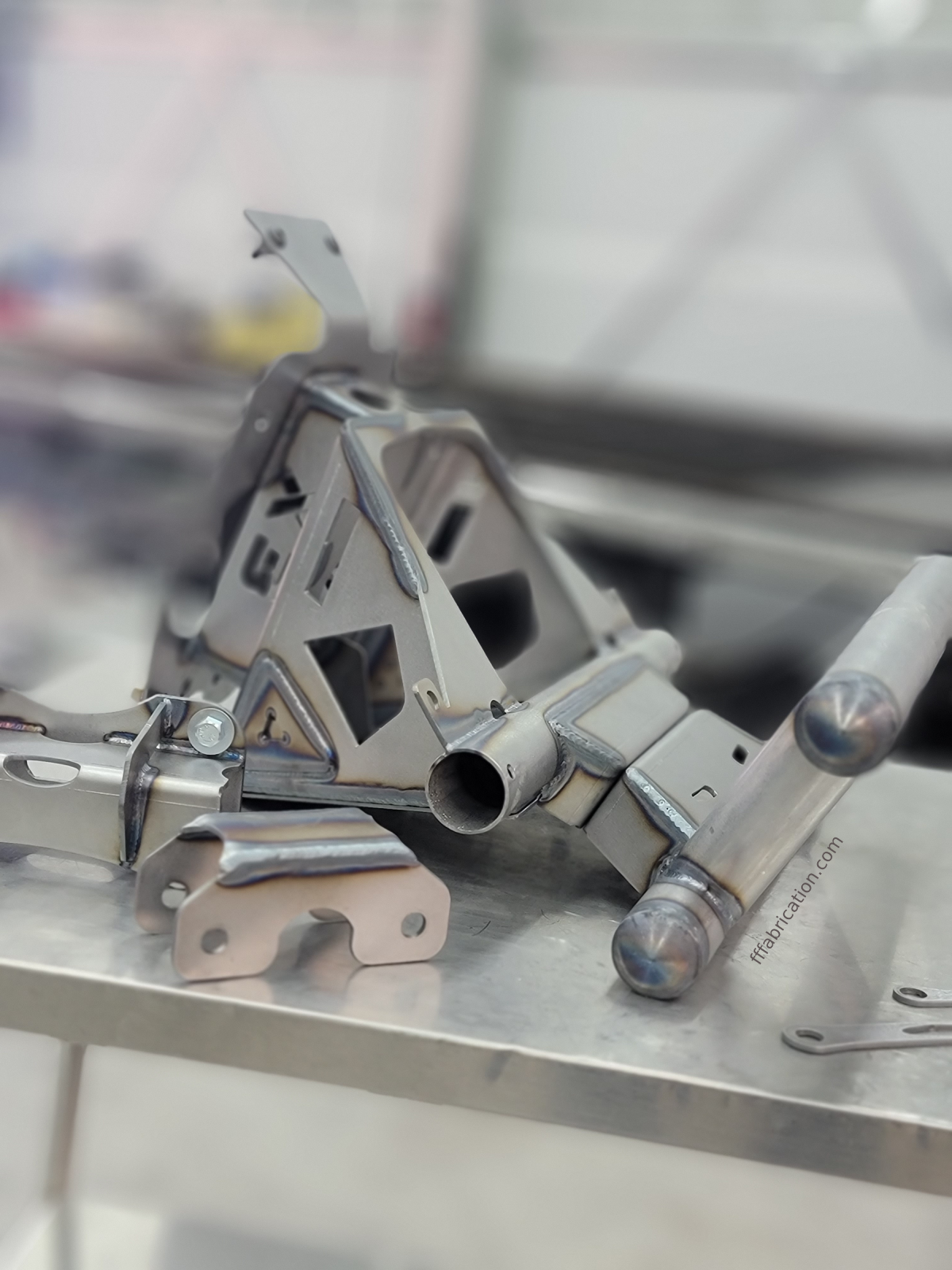 Metal folding chair mechanism on a reflective surface with a blurred background