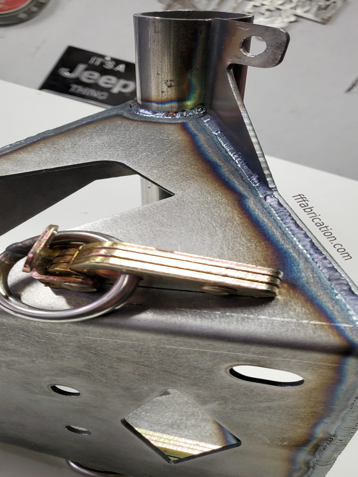Metallic keychain with keys on a metallic surface
