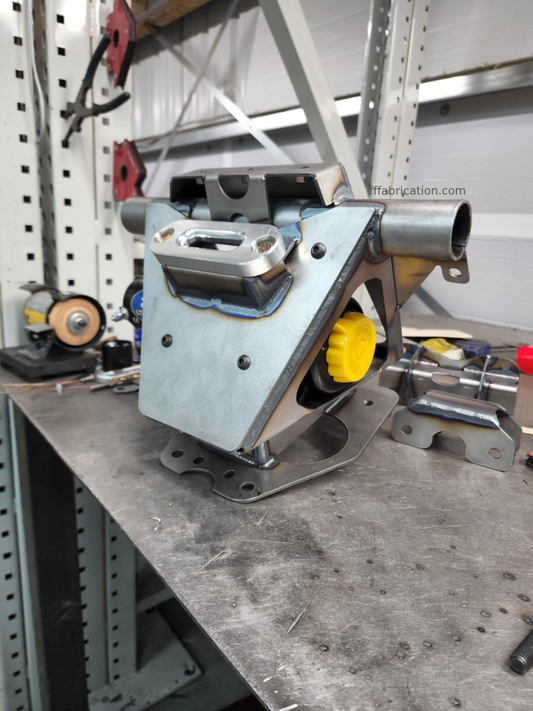 Metal mechanical component on a workbench with tools in the background
