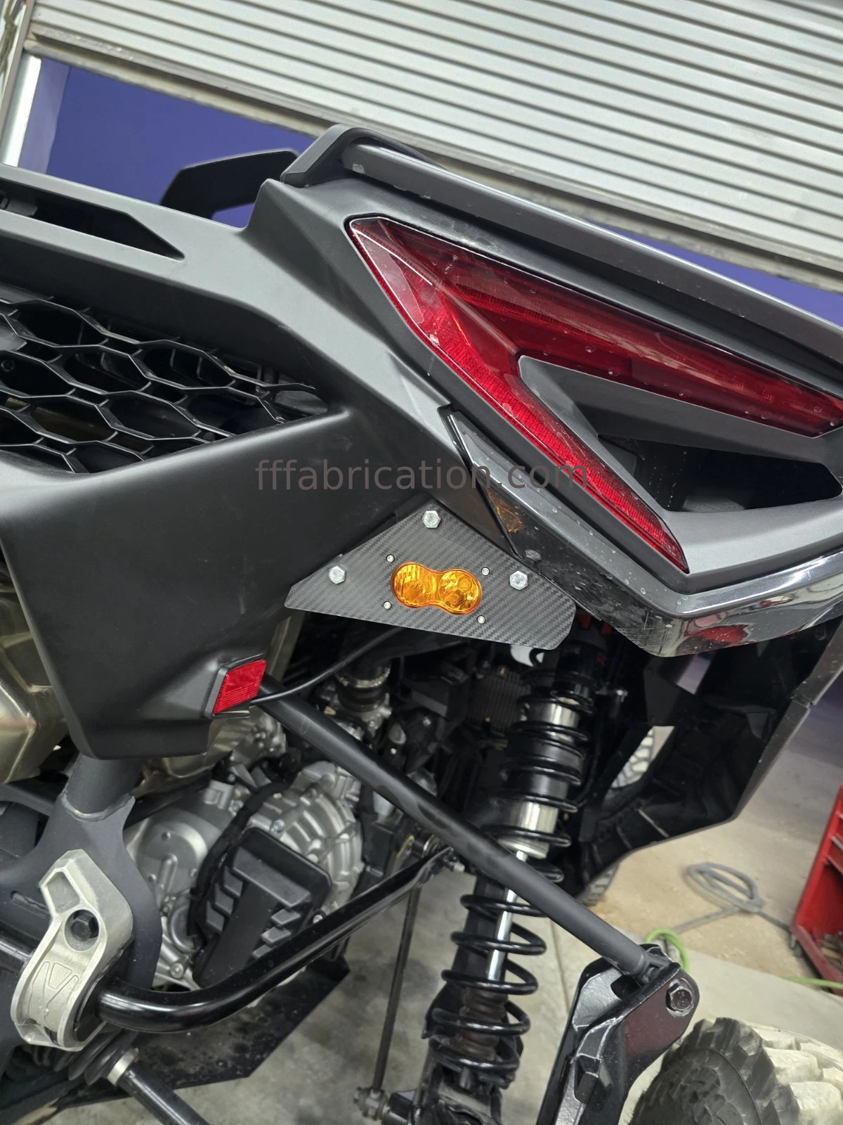 Close-up of a motorcycle's rear section with a visible brand name.