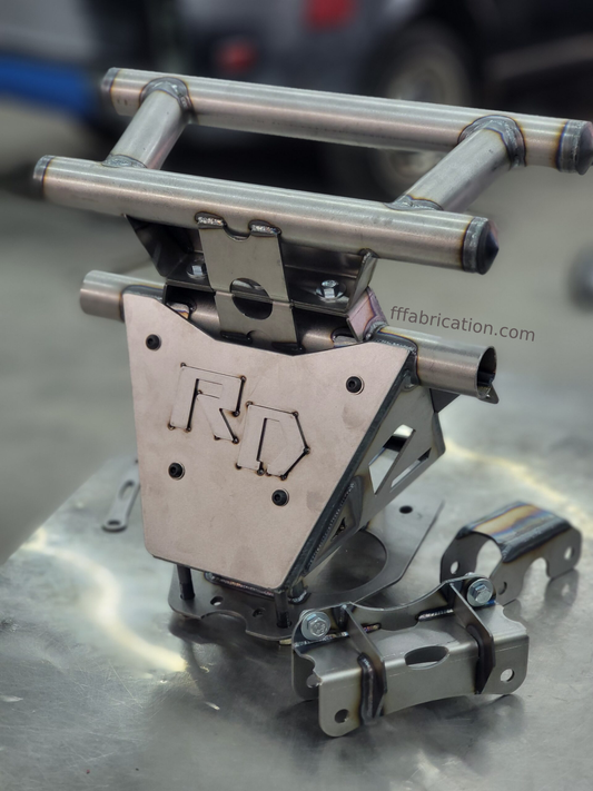 Metal fabrication component with 'R D' branding on a metallic surface