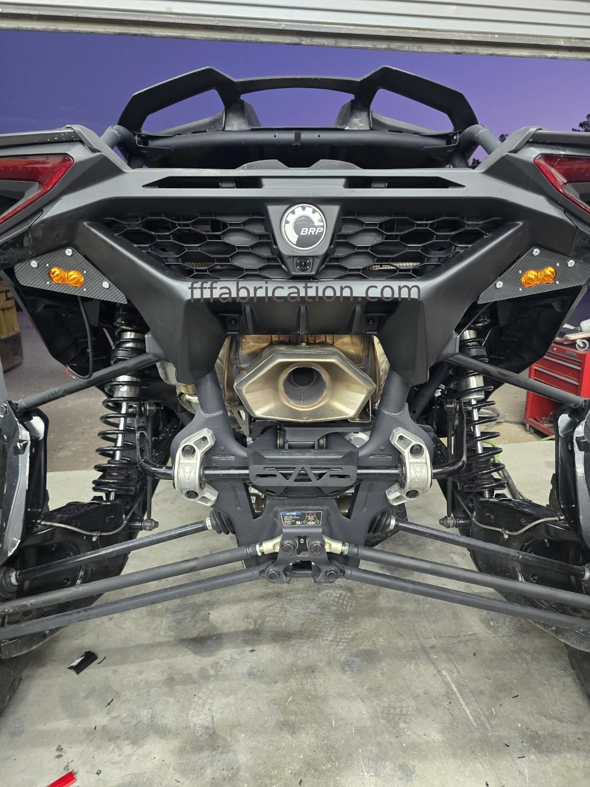 Close-up of a mechanical component with visible branding on a workshop floor.