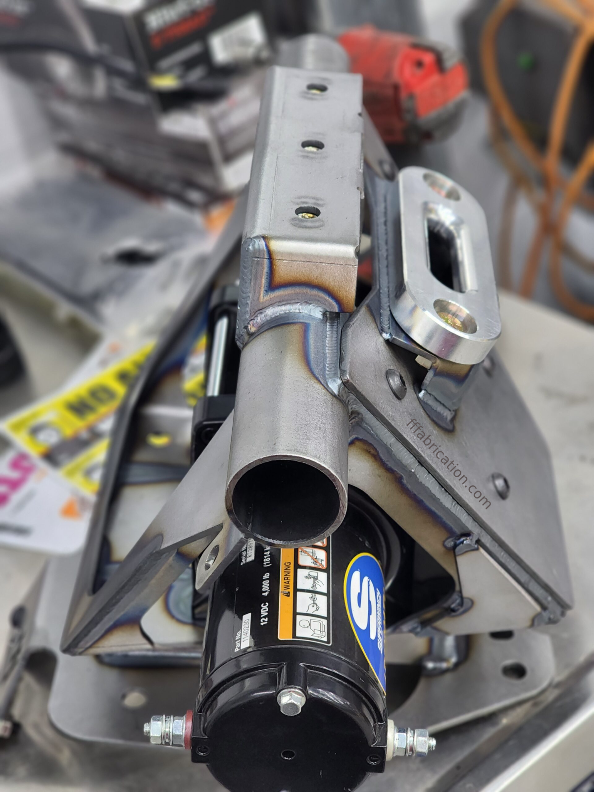 Metal mechanical component with visible branding in a workshop setting