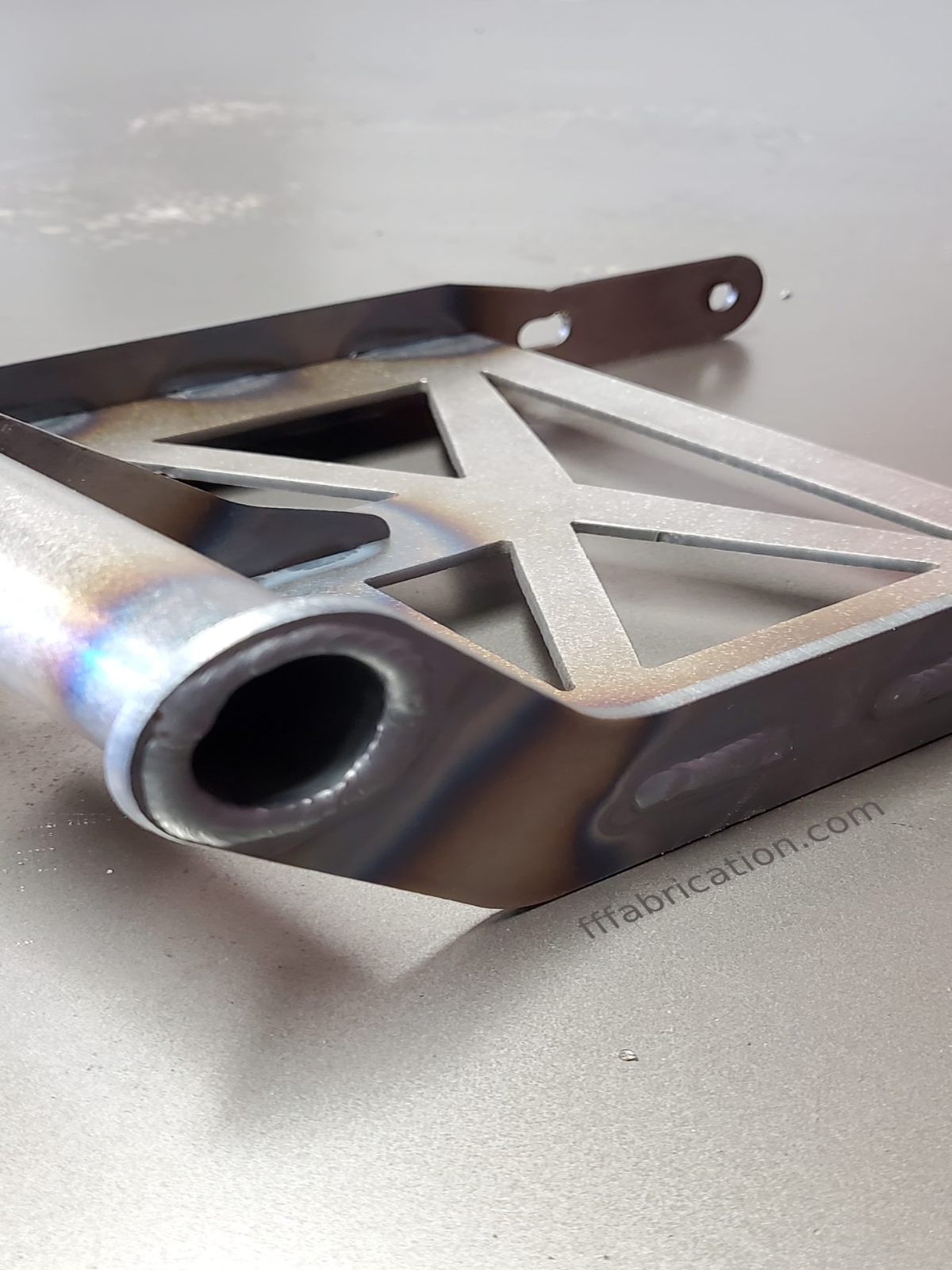Metallic exhaust pipe on a gray background