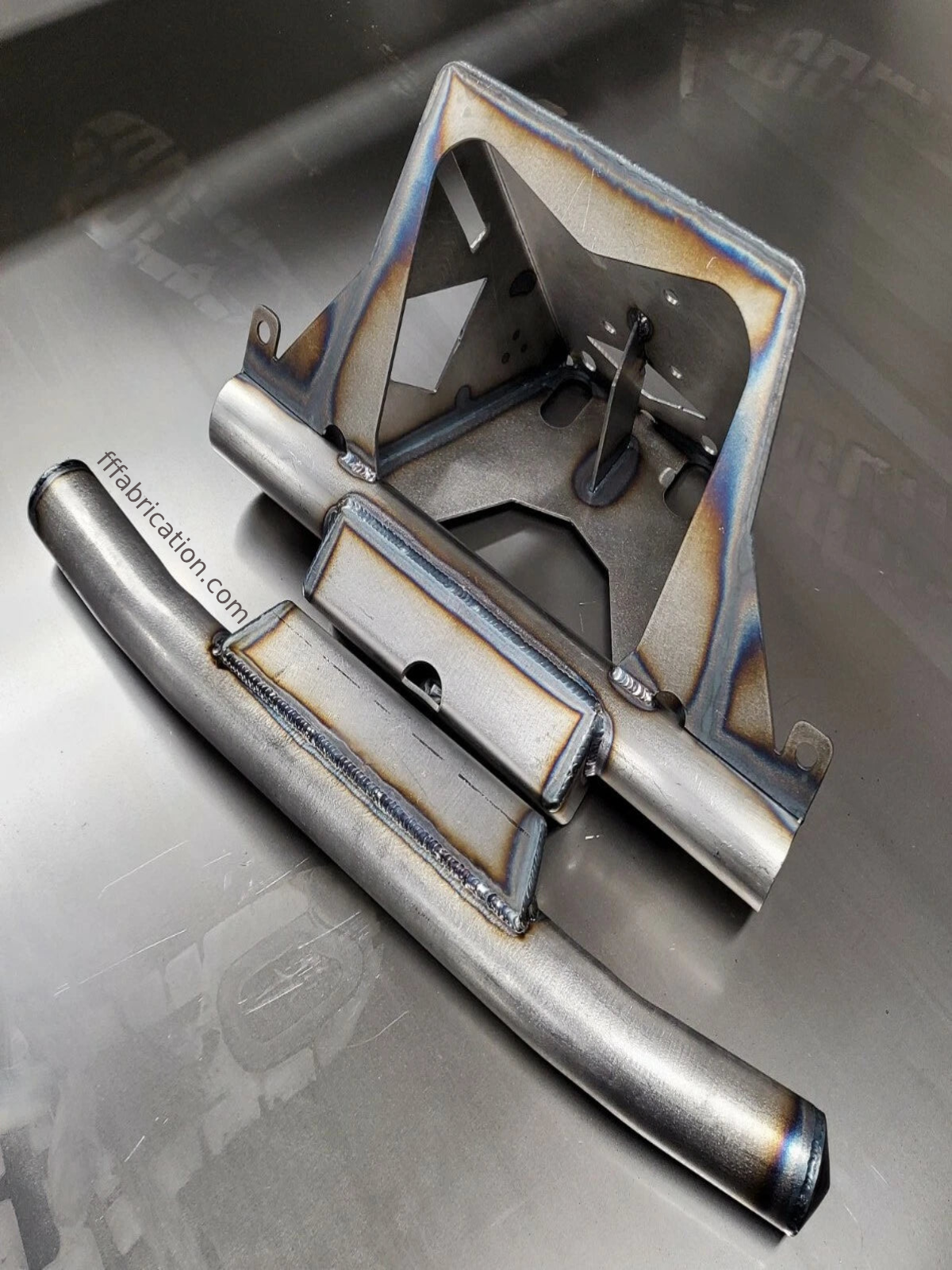 Metallic object with a textured surface on a reflective metallic background