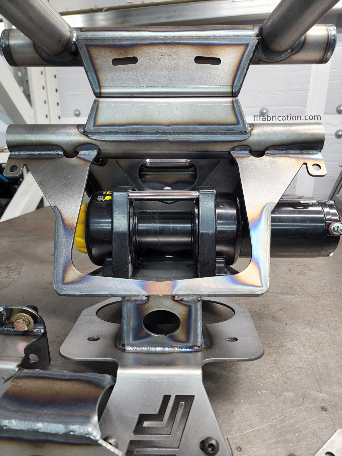 Metal mechanical component with visible branding on a workshop background