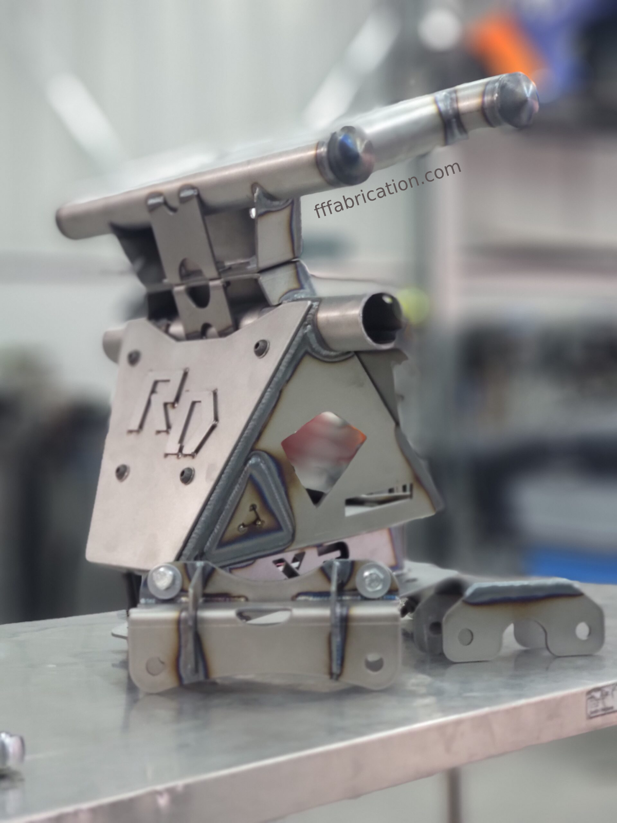 Metal fabrication tool on a metallic surface with blurred background