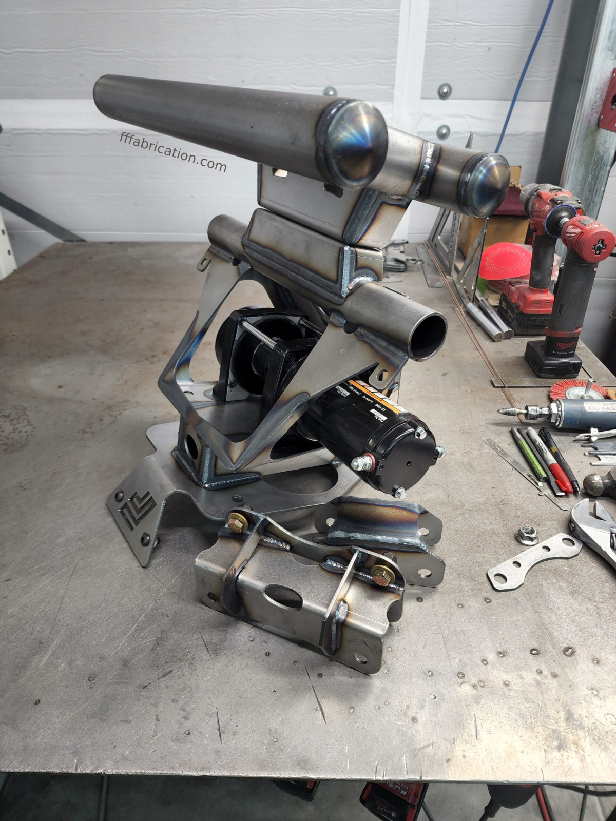 Metalworking tool on a workbench with tools and equipment in the background