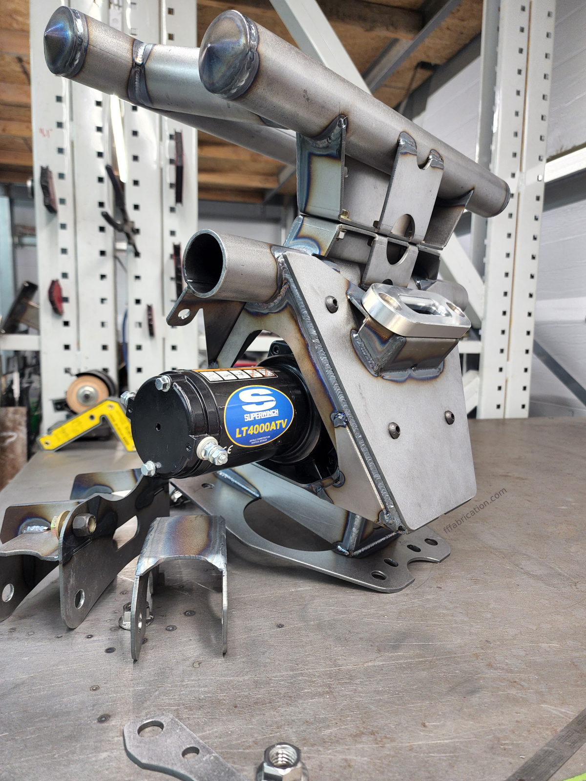 Metal mechanical component with a brand logo on a wooden surface