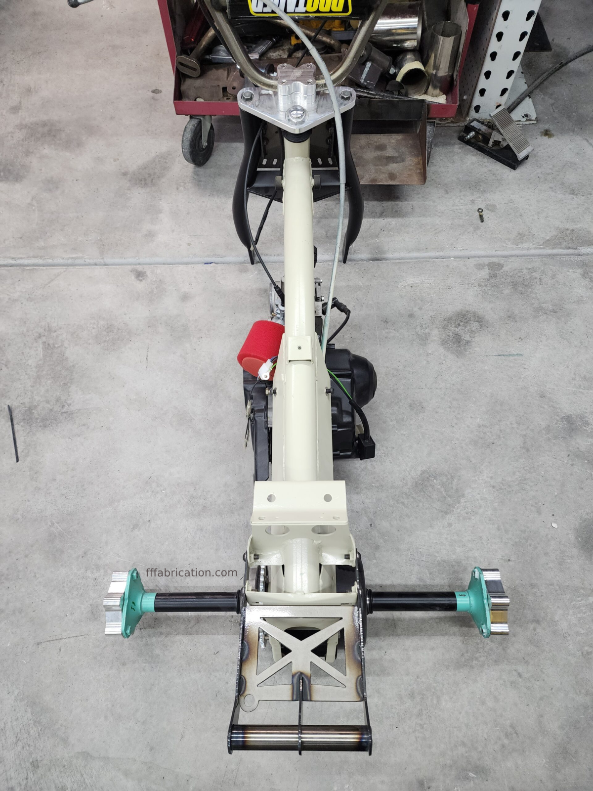 Mechanical lift or jack on a concrete floor with visible branding.