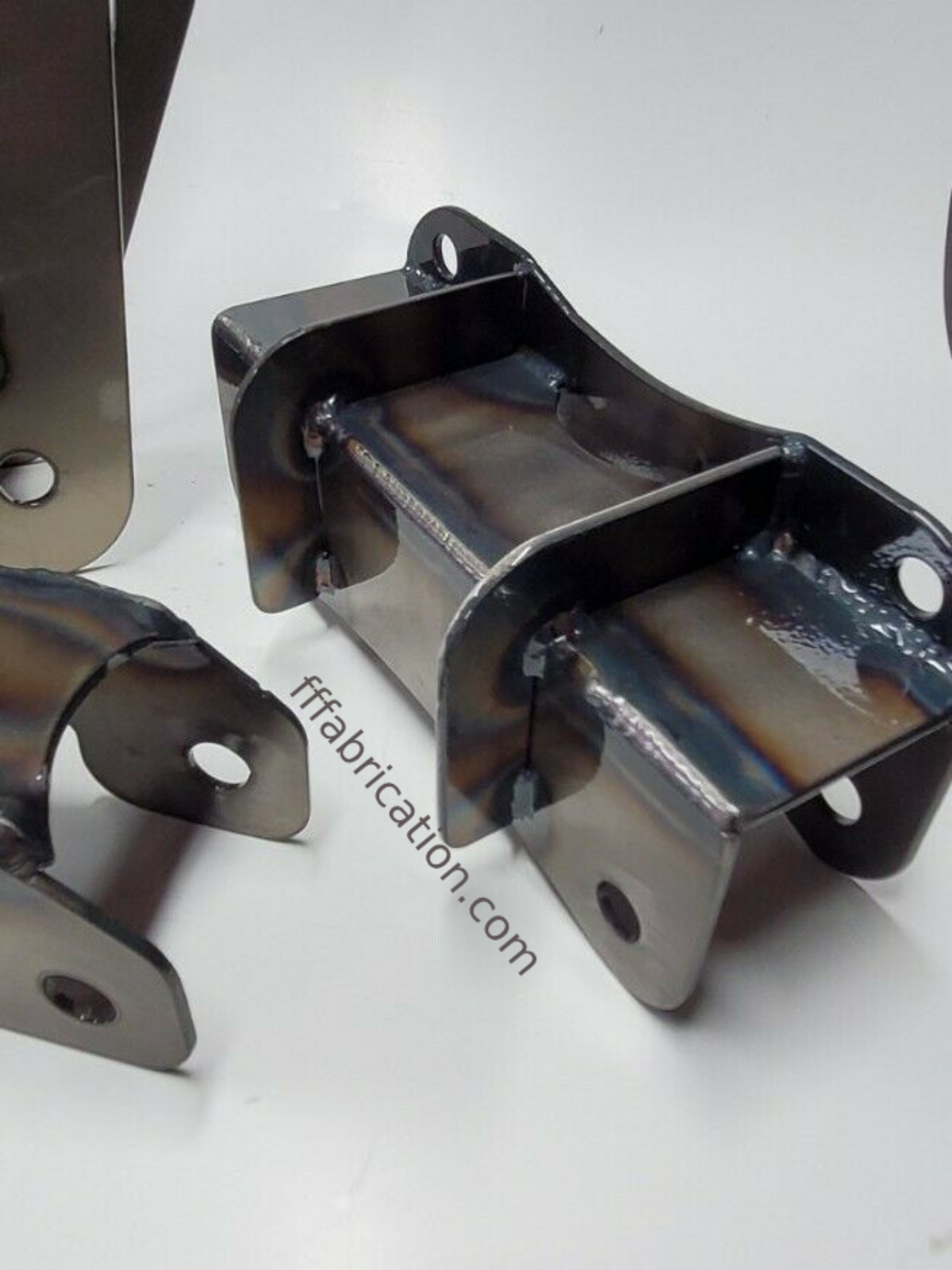 Metal fabrication components on a white background with 'fffabrication.com' text.