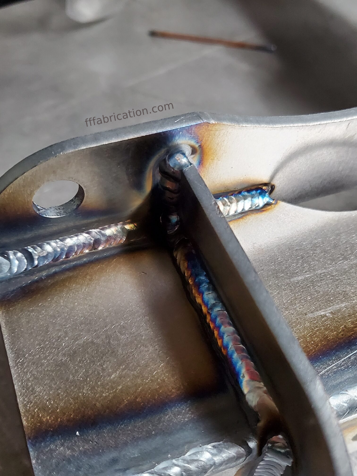 Metal fabrication process with a weld on a metal bracket.
