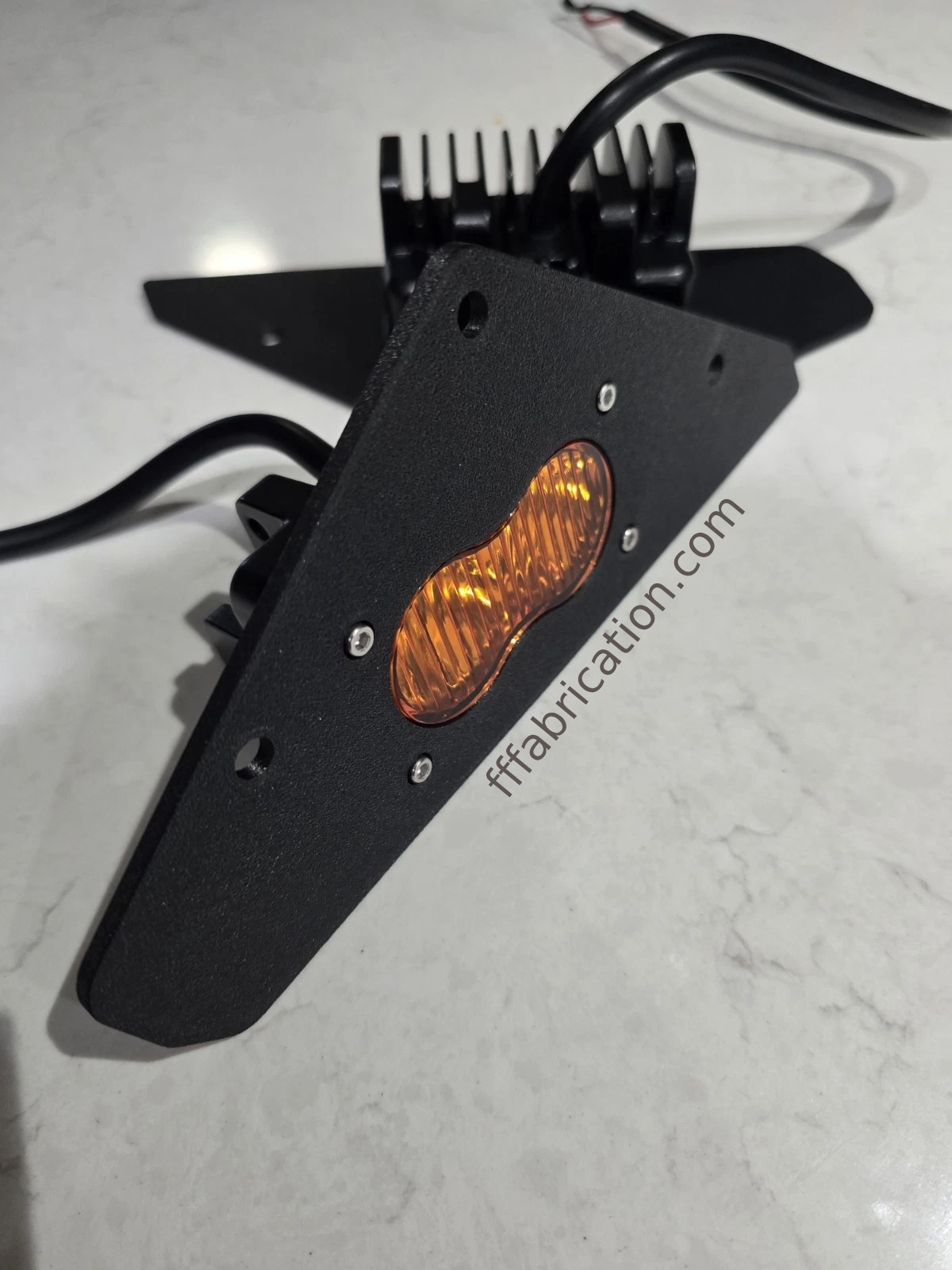 Amber LED light with black housing on a white background, featuring 'fffabrication.com' branding.